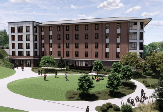 High-Wide walkway between modern brick-and-glass campus buildings, leading toward a distant domed structure under a cloudy sky.rise campus residence hall exterior