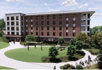 High-Wide walkway between modern brick-and-glass campus buildings, leading toward a distant domed structure under a cloudy sky.rise campus residence hall exterior.