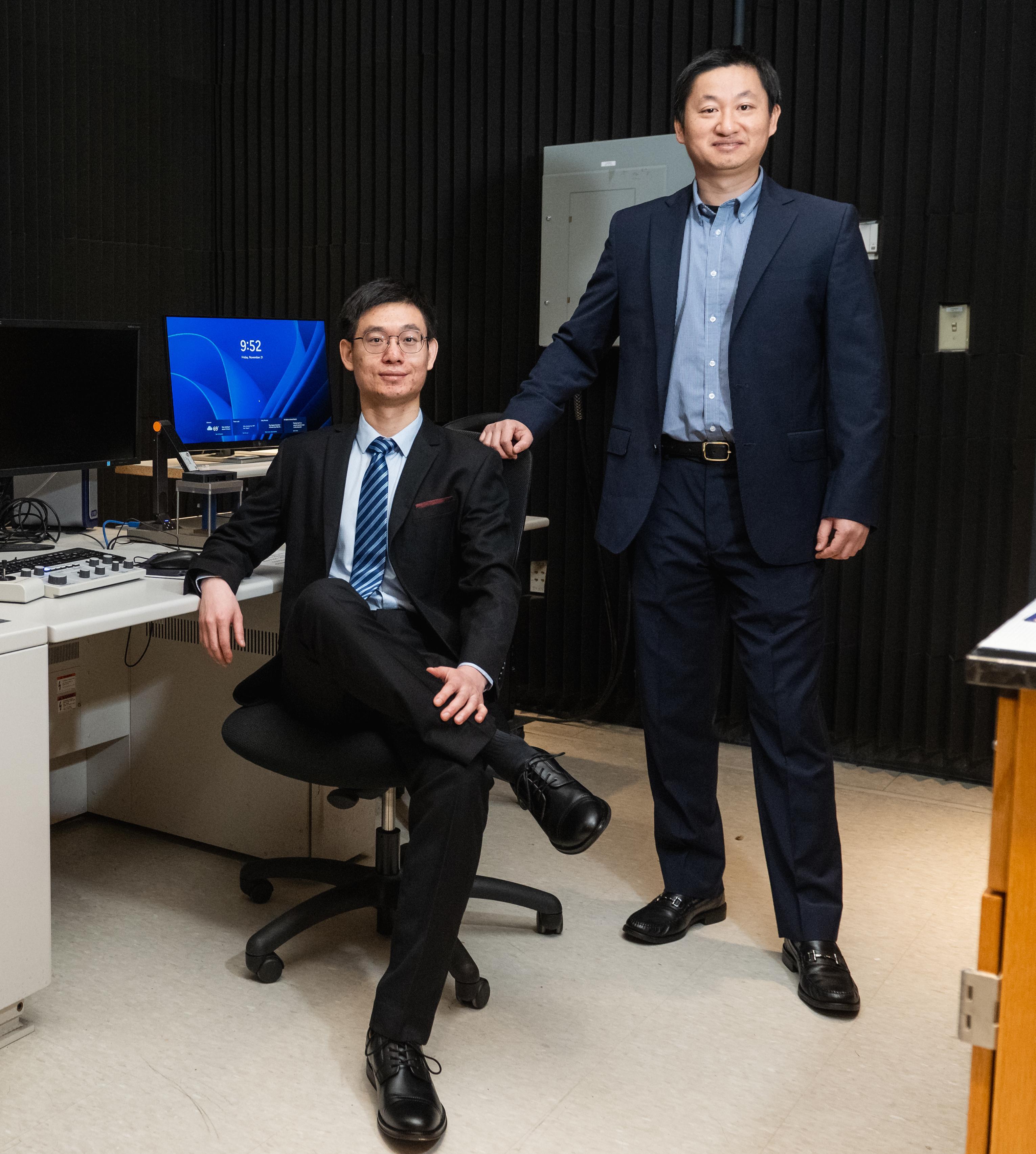 Hui sitting on the chair on the left with faculty advisor Wu